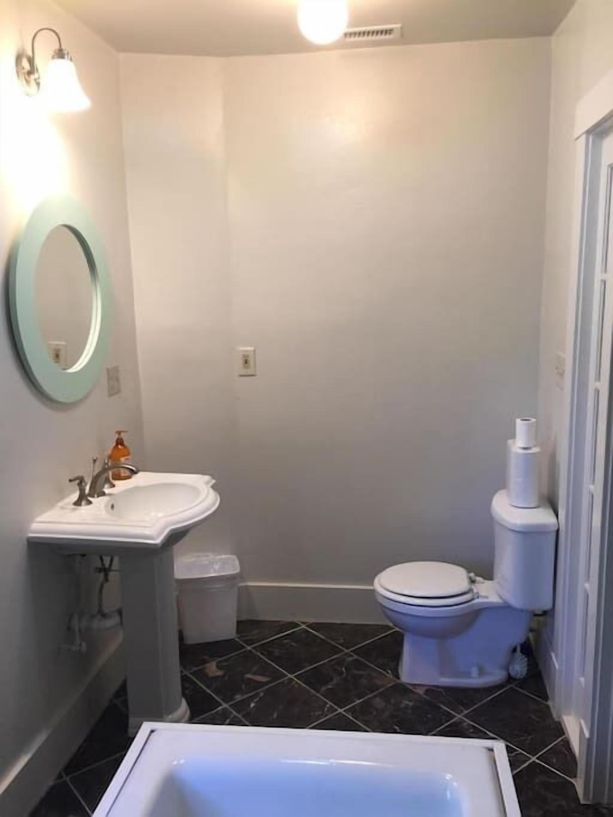 A bathroom with a white sink, toilet, and bathtub.