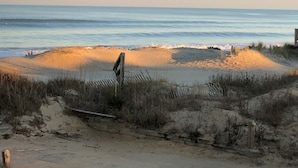 A beach with a wooden fence and a signpost, leading to the water. - Saltaire Cottages8: 2BR Ocean View Steps2 Private Beach Access Screen Porch Pool (Kitty Hawk)