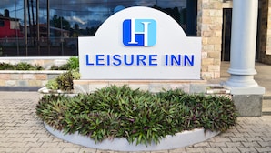 A sign for the Leisure Inn with a logo and name. - Leisure Inn (New Amsterdam)