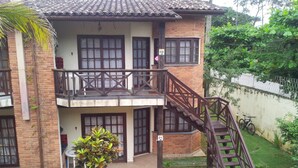 A two-story house with a balcony, a staircase, and a small garden area. - 2 bedrooms, 1 suite, 2 bathrooms, 100 m from the best location in Praia da Baleia. (São Sebastião)