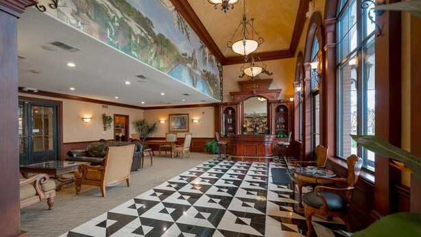 A lobby with a checkered floor, wooden furniture, a mural on the ceiling, and a bar area. - A beautiful codo in the heart of Sugar Land ( Houston suburb) (Sugar Land)