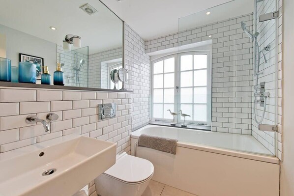 Bathtub, hair dryer, towels, soap