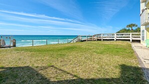 A grassy area with a wooden deck leading to a white fence overlooking the ocean. - ☀️Beachfront Complex-Top Floor-30A-Driftwood Cottage (Santa Rosa Beach)