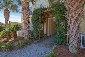 Enter a serene oasis surrounded by lush greenery and mature palm trees.