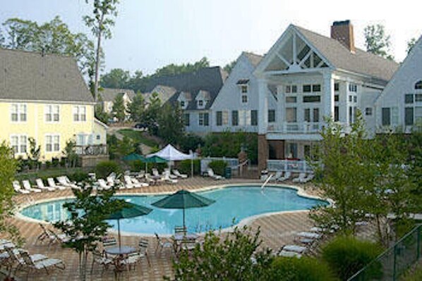 Relax by the resort's inviting pool surrounded by lounge chairs and umbrellas.