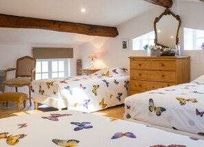 A bedroom with two beds, a wooden dresser, a chair, and a window. - Homerez - Villa in Arsac with pool (Arsac)