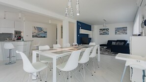 A modern kitchen with white cabinetry and a built-in microwave. - Villa Compass Luxury in a natural bay (Rogoznica)