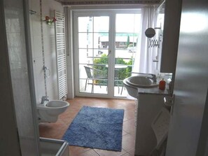 A bathroom with a toilet, sink, and shower area. - FEWO III - Villa Roder (Freiburg im Breisgau)