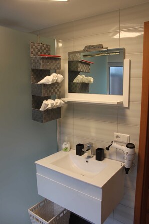 Shower, hair dryer, towels, toilet paper