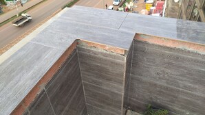 A view of a street from a high vantage point, with a building's roof in the foreground. - Airport Hotel Entebbe (Entebbe)
