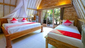 A bedroom with two wooden beds, white bedding, red pillows, and a canopy bed. - Alibaba Bungalows (Gili Air)