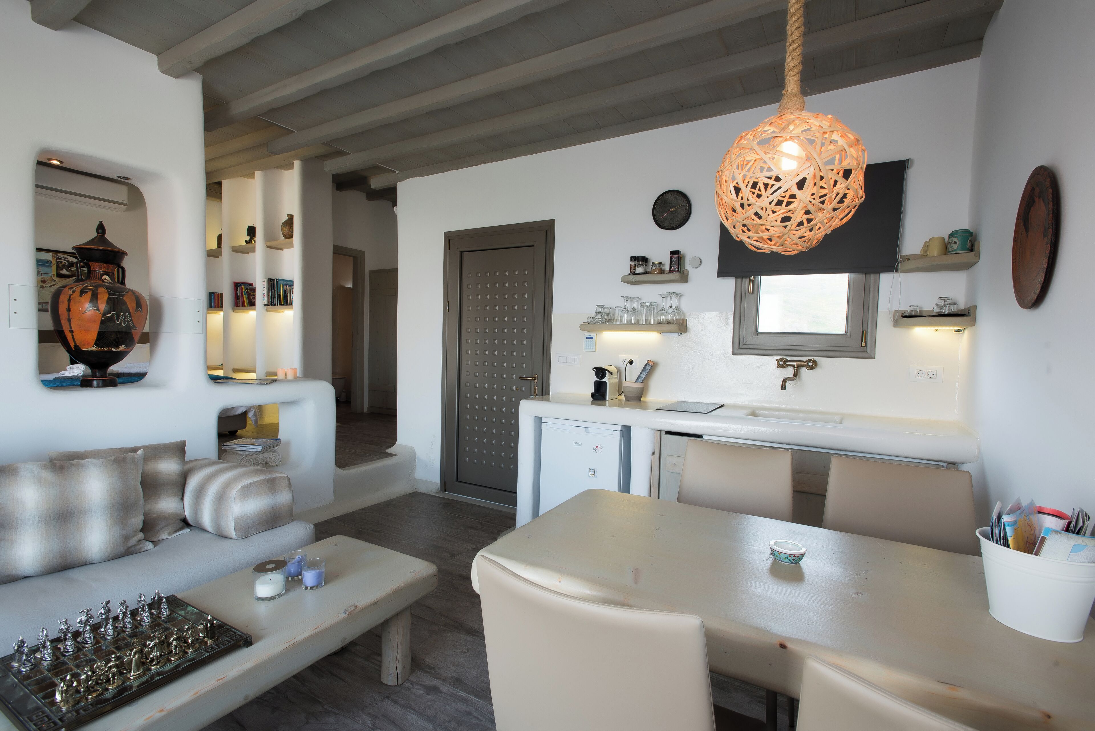 Un salon moderne comprenant un canapé, une table à manger et un coin cuisine.