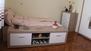 A bedroom with a bed, a bedside table, a dresser, and a cabinet. - Studio Zsofia in Budapest (Budapest)