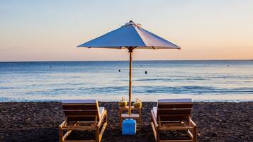 On the beach, sun loungers, beach umbrellas, beach towels