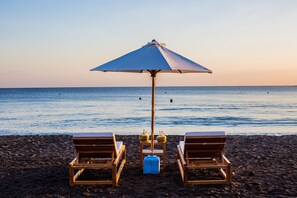 On the beach, sun-loungers, beach umbrellas, beach towels