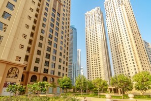 A high-rise building with multiple floors, large windows, and a modern architectural design. - Elegant Studio In Murjan 2 JBR (Dubai)