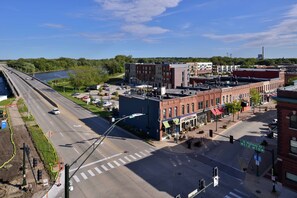 A street view with a river, buildings, and a bridge.