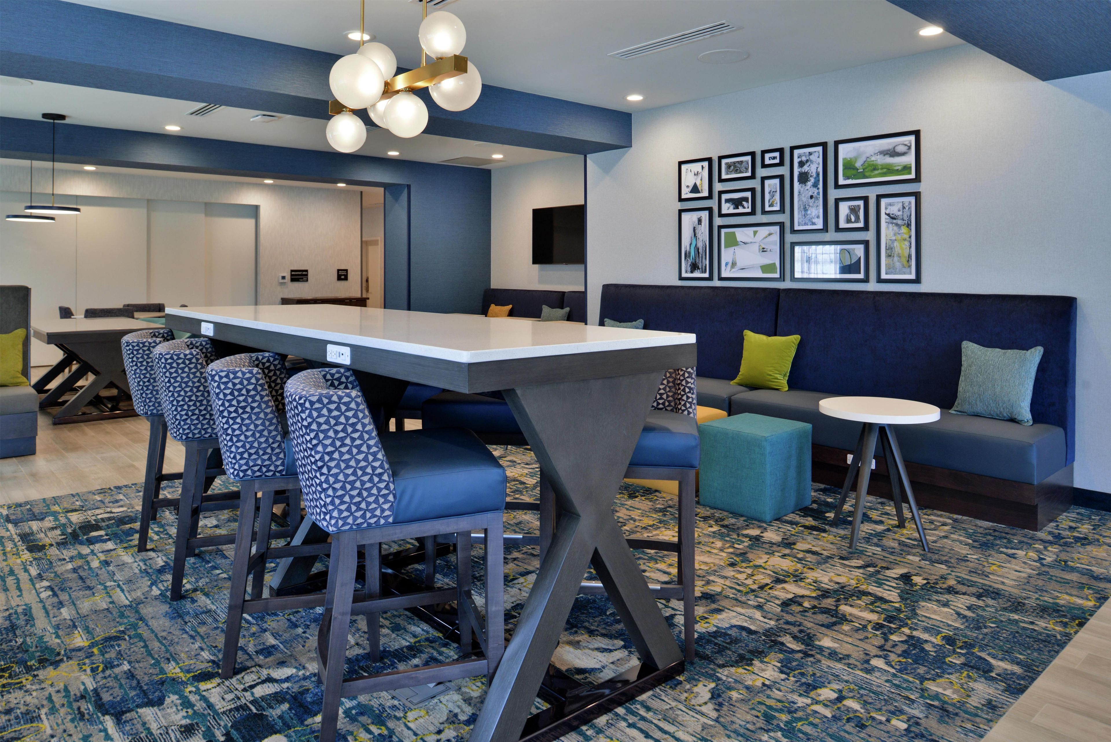 A modern interior with a dining area, seating, and artwork on the walls.