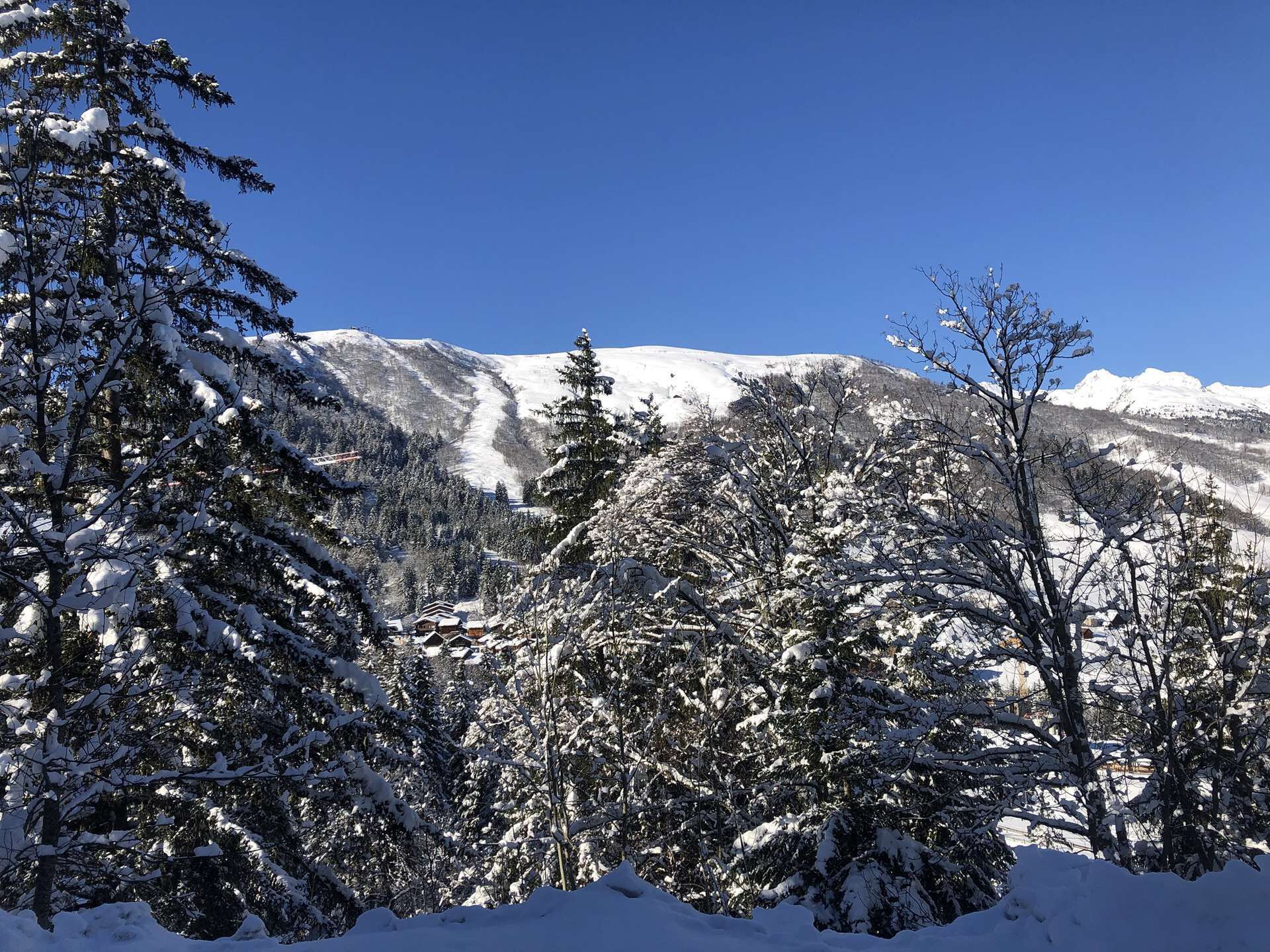 A snowy mountain landscape with a clear blue sky.