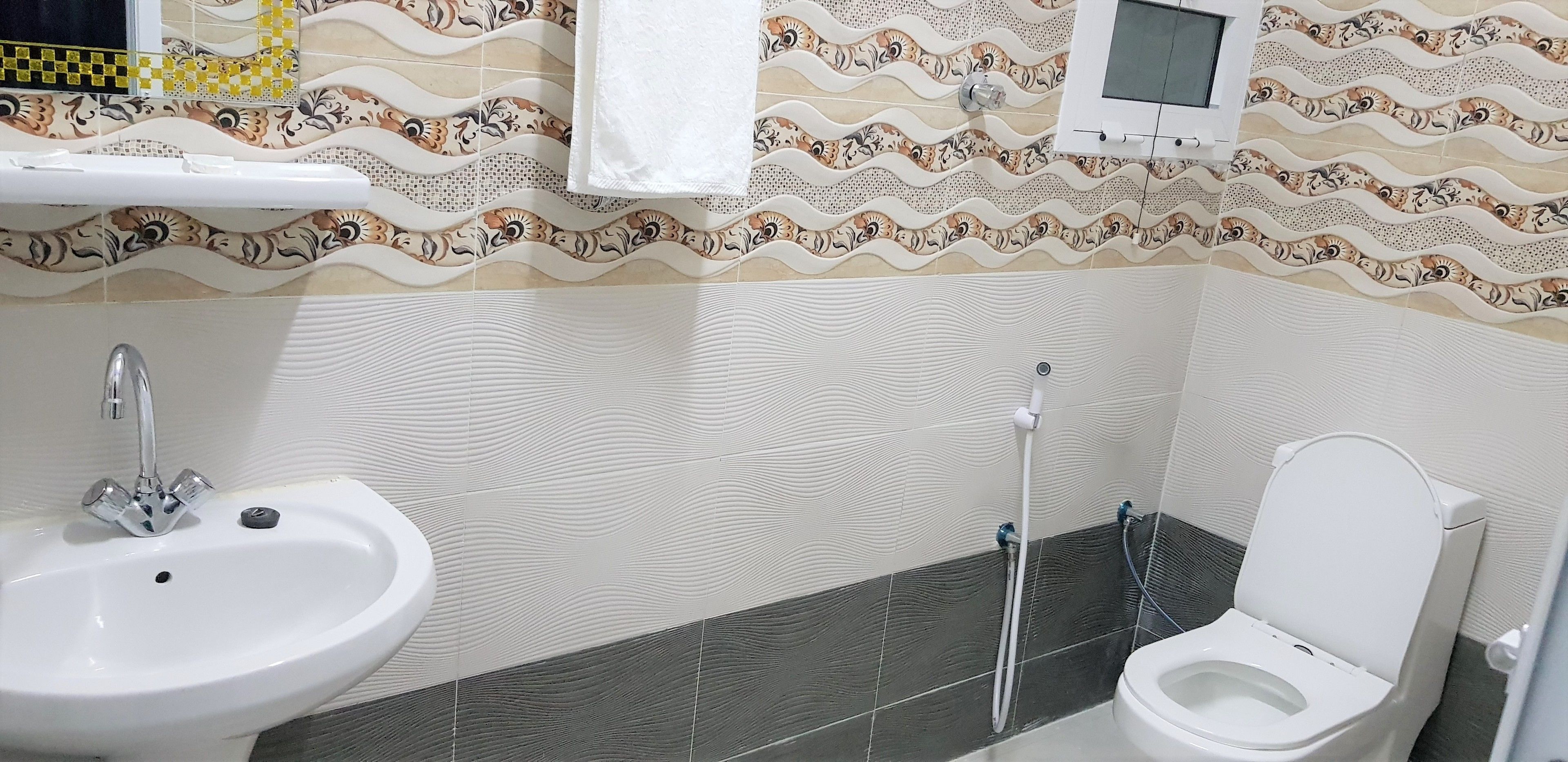 A bathroom with a sink, toilet, and shower.