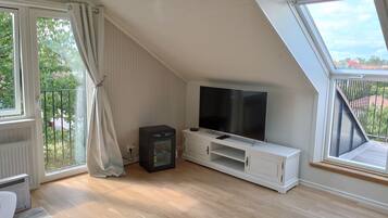 Deluxe Condo, City View | Living room | Plasma TV, heated floors