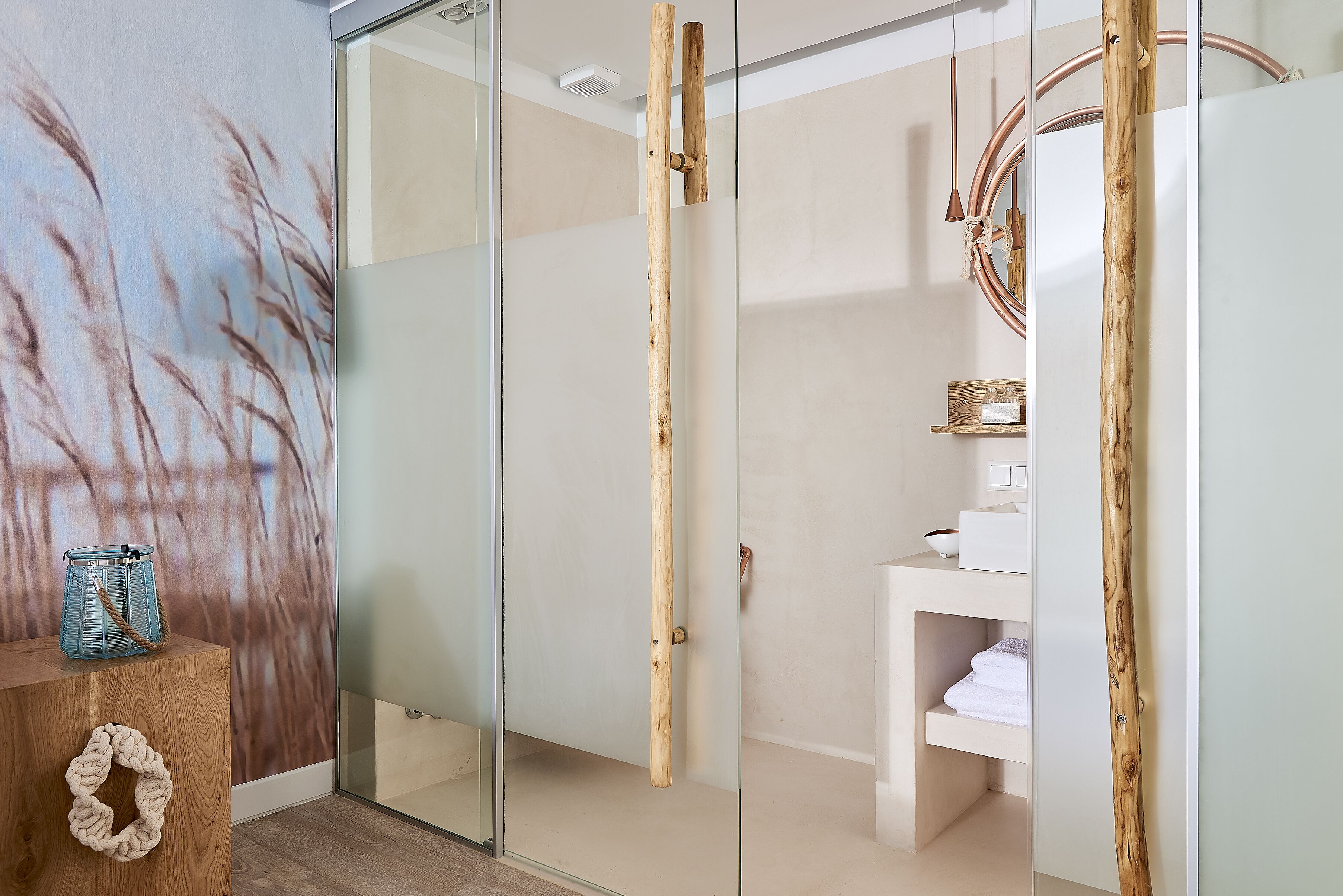 A modern bathroom with a glass shower enclosure, wooden accents, and a minimalist design.