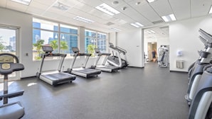 A gym with treadmills, a stationary bike, and a weight machine.