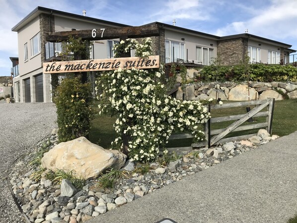 A modern building with a sign reading "the mackenzie suites." - The Mackenzie Suites (Lake Tekapo)
