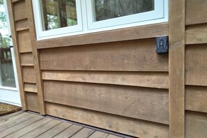 A wooden exterior wall with horizontal siding and a window.