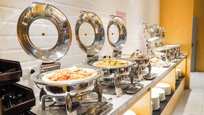 A buffet setup with multiple round serving dishes and a variety of food items. - Hotel A . Tainan (Tainan)
