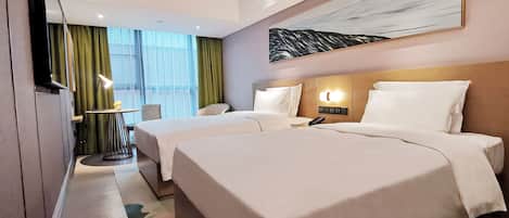 A hotel room with two beds, a desk, a chair, a TV, and a painting on the wall.