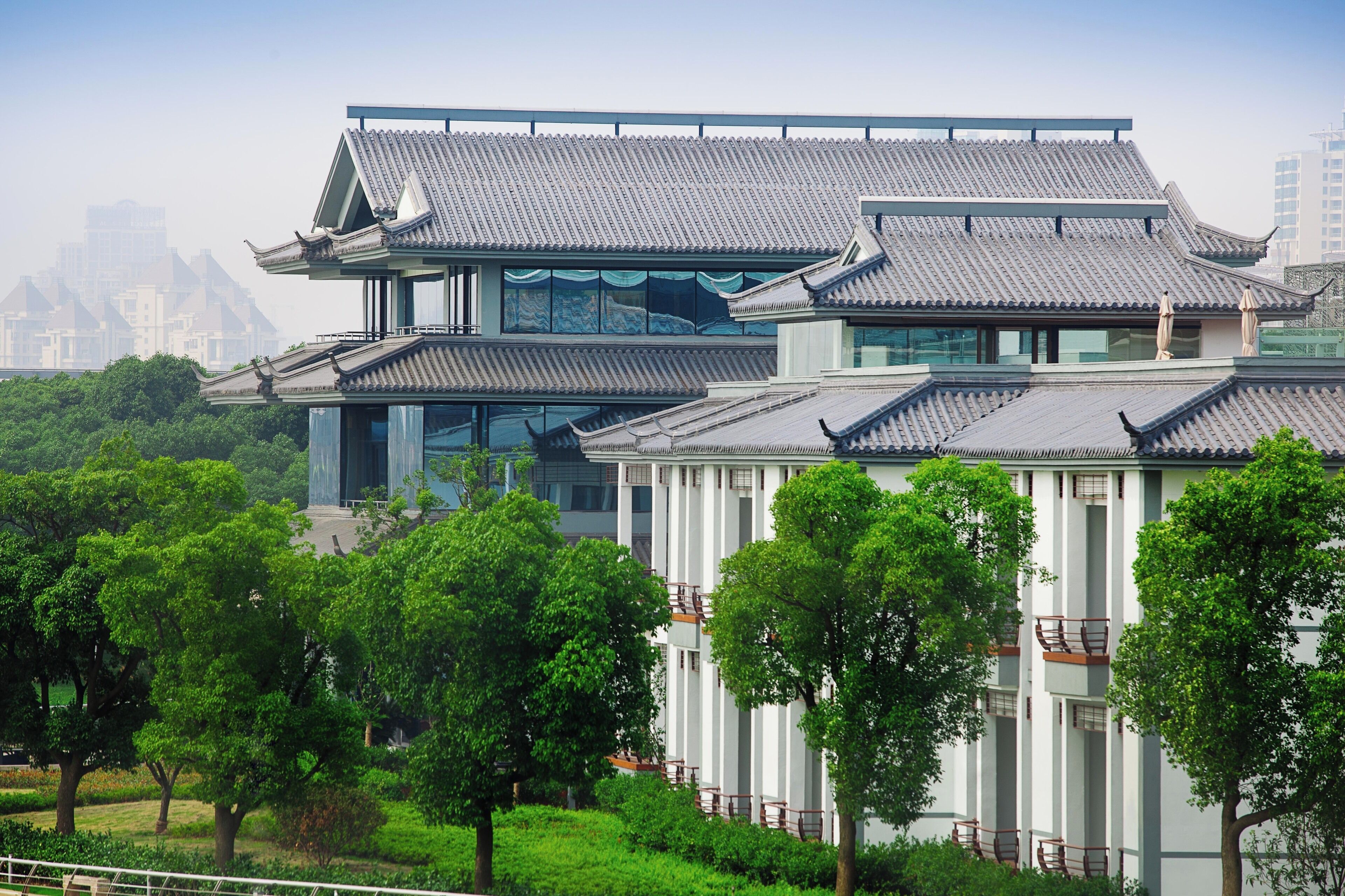A traditional building with multiple levels and a modern glass facade.