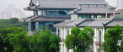 A traditional building with multiple levels and a modern glass facade.