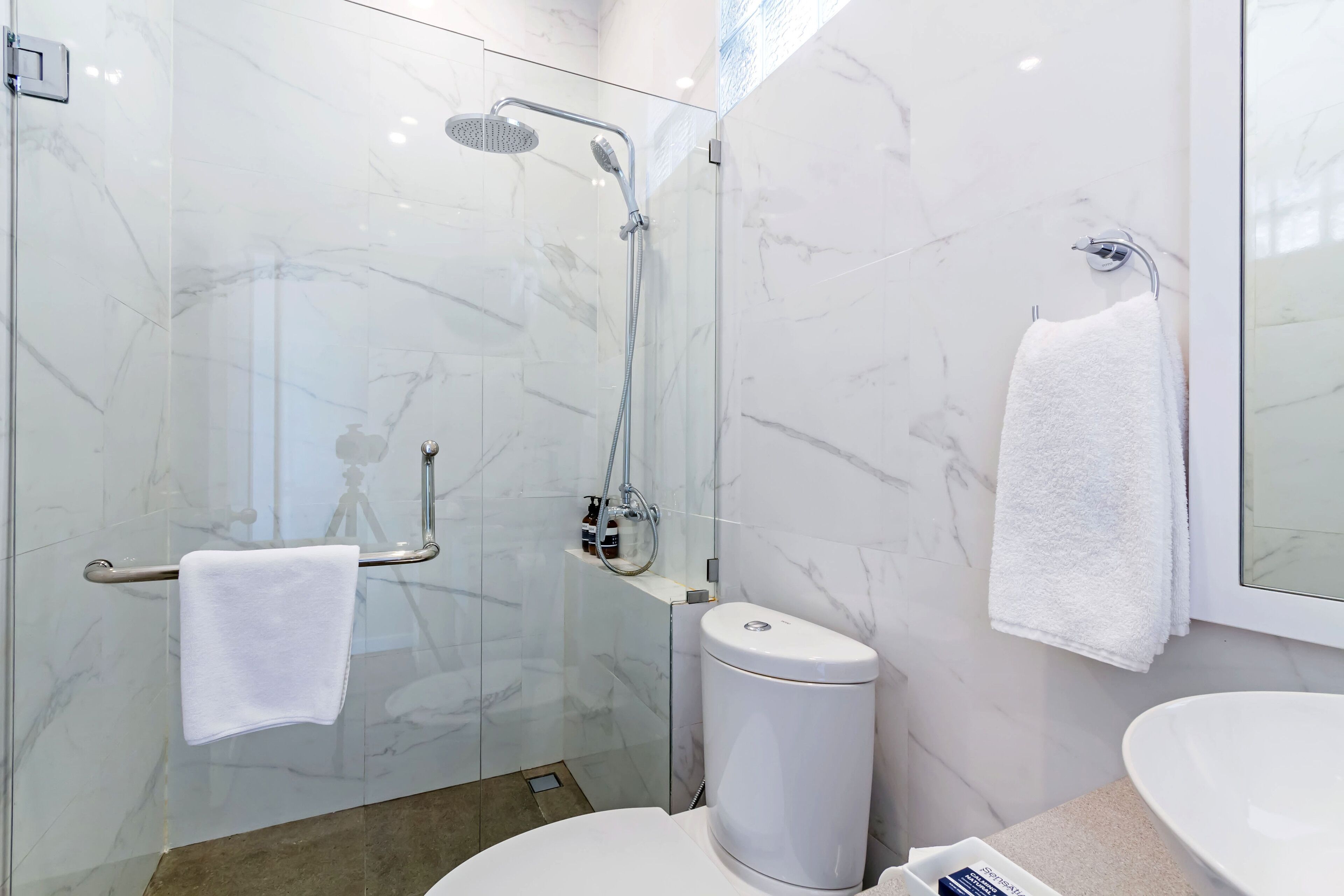 shower, hair dryer, slippers, towels