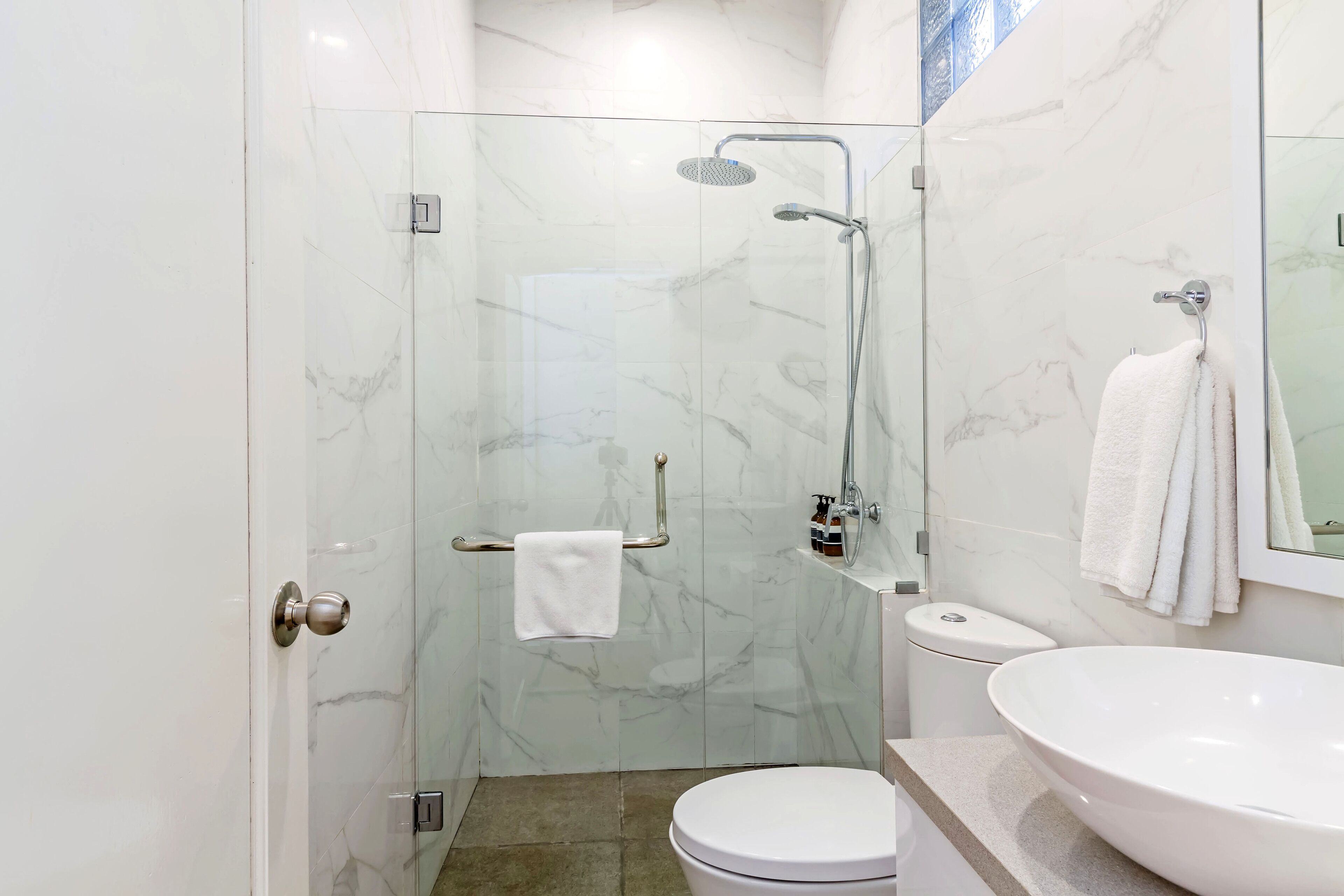 shower, hair dryer, slippers, towels