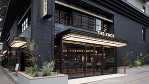 A modern building with a sign reading "THE KNOT".