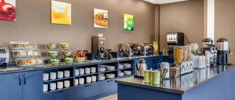 A self-service breakfast bar with various food items, bowls, and utensils.