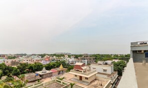 A residential area with various buildings, including houses and a temple. - Treebo Concerto Residentia (Durgapur)