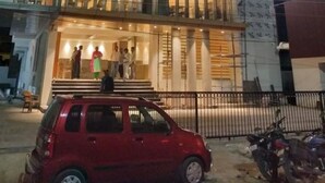 A hotel with a modern facade, large windows, and a visible entrance with people outside. - Hotel Le Lotus Grand Varanasi (Varanasi)