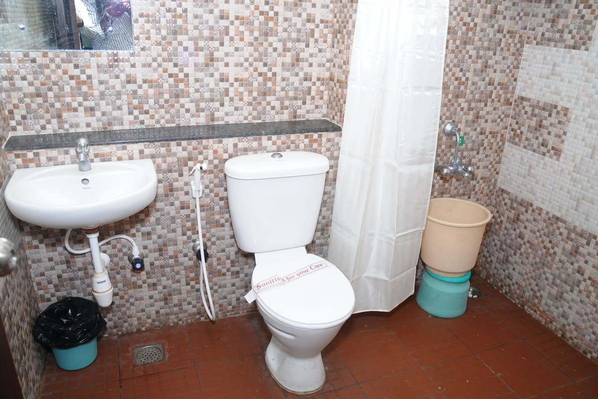 A bathroom with a sink, toilet, and shower curtain.