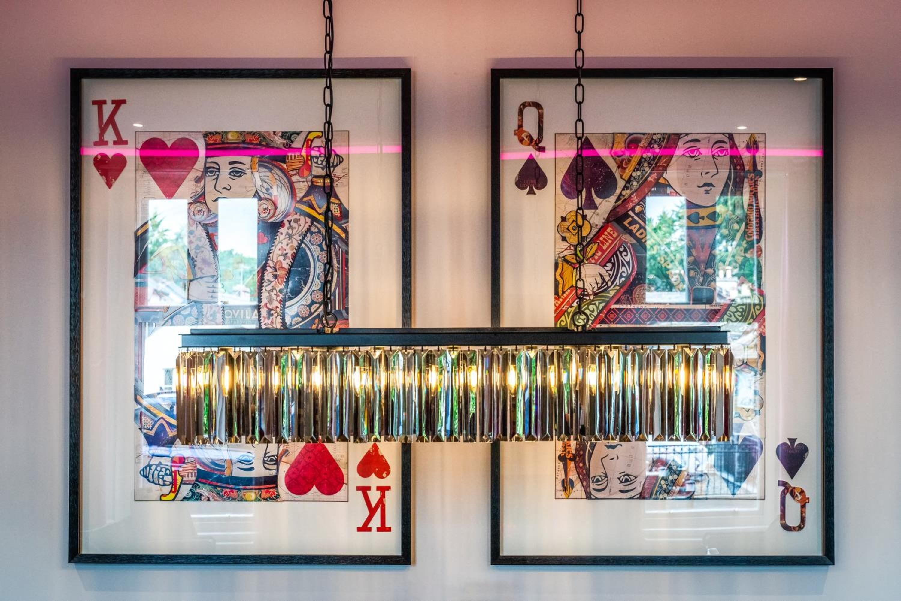 Two framed artworks with card designs and a reflective strip below.
