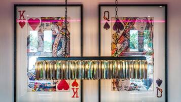 Two framed artworks with card designs and a reflective strip below.