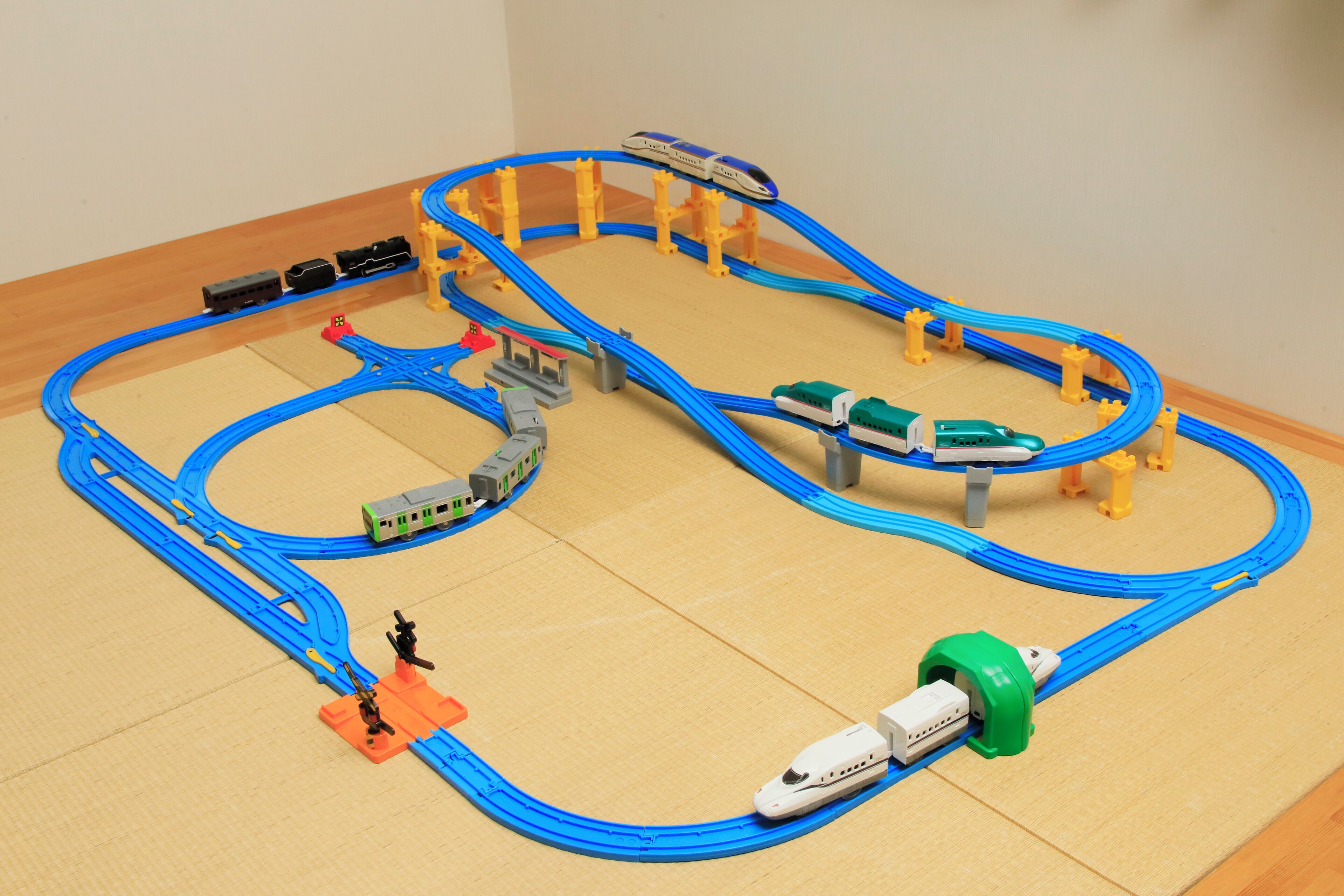 A model train layout with multiple tracks and trains.
