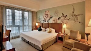 A hotel room with a large bed, two bedside lamps, a chair, a desk, and a large window with curtains. - Hangzhou Wenhua Jinglan Grand Hotel (Hangzhou)