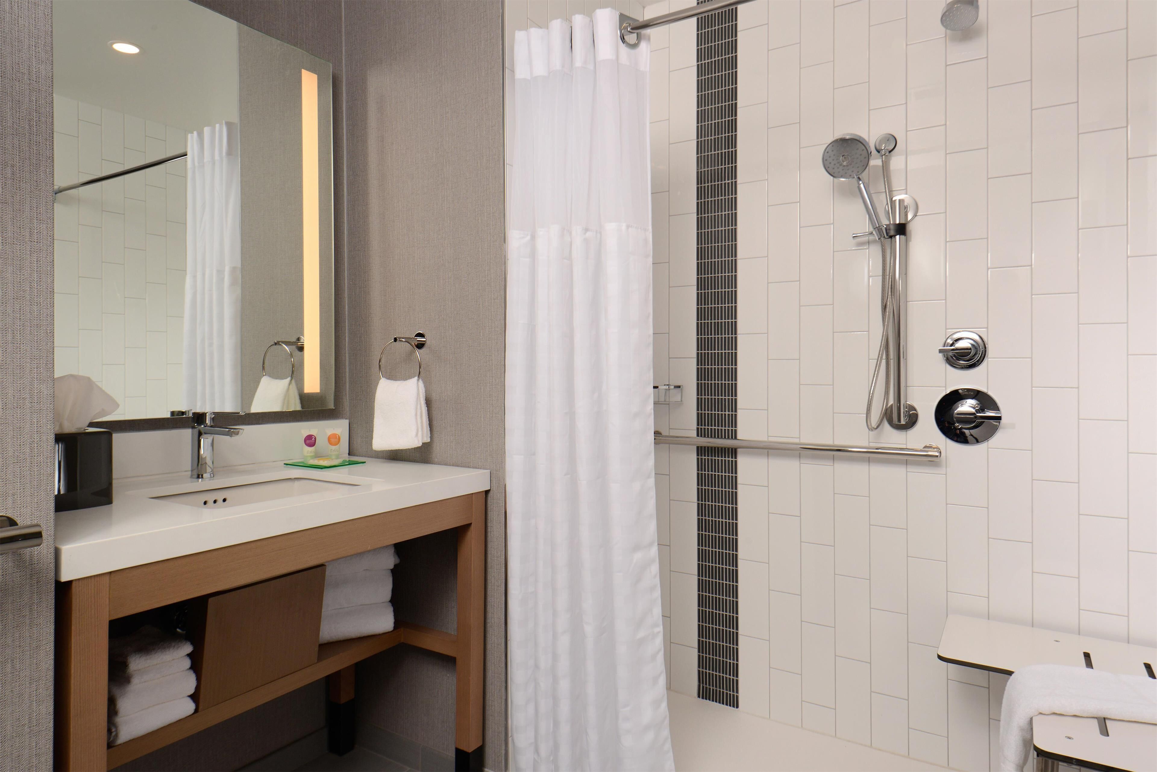 combined shower/bathtub, designer toiletries, hair dryer, towels