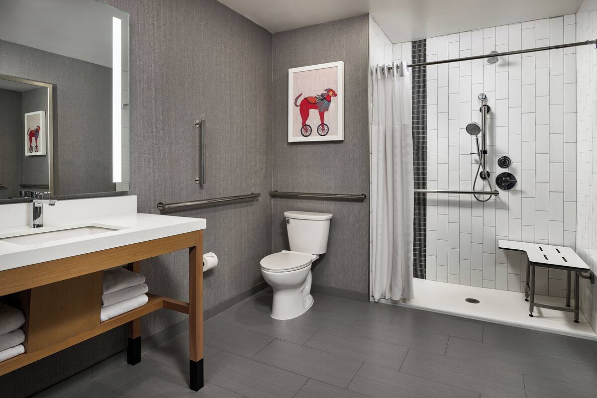 combined shower/bathtub, designer toiletries, hair dryer, towels