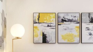 A modern living room with a sofa, three abstract paintings, and a floor lamp. - Floral Hotel Hangzhou Puyushanyu (Hangzhou)