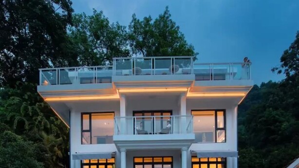 A modern two-story house with a balcony, large windows, and a well-lit entrance. - Floral Hotel Hangzhou Puyushanyu (Hangzhou)