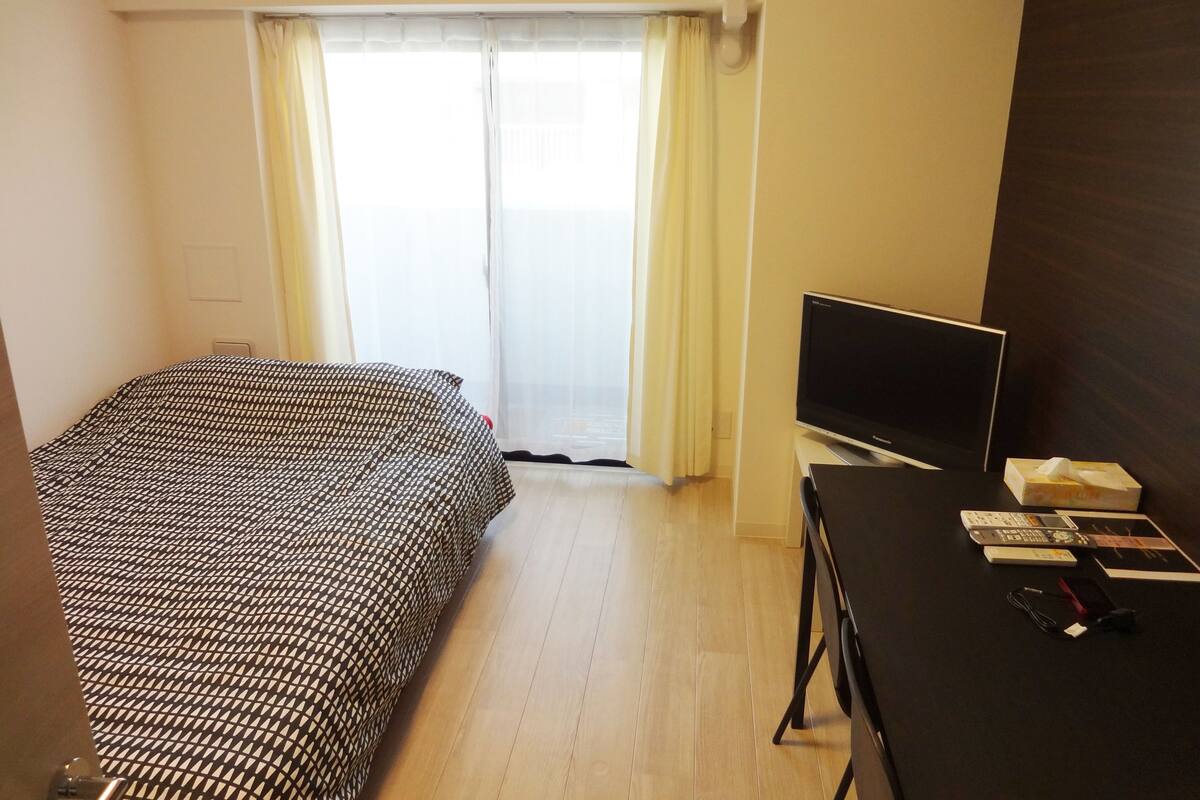 Desk, laptop workspace, blackout drapes, iron/ironing board