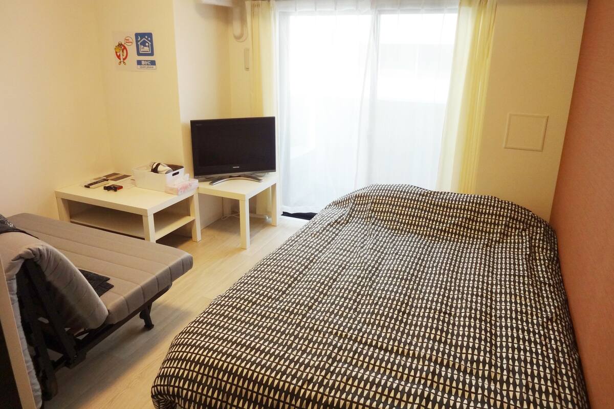 Desk, laptop workspace, blackout drapes, iron/ironing board
